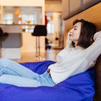 lovely shorthair model have a rest have a daily nap sitting in blue bag chair at home